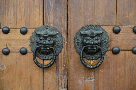Old chinese door with lion head metal knockersの写真素材