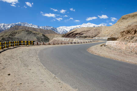 Curved road in high mountain pass in Ladakhの写真素材