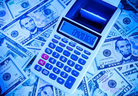 Calculator on the background of banknotes dollarsの写真素材