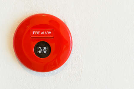 Red fire alarm on a wallの写真素材