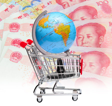 Earth on shopping cart with chinese currency background