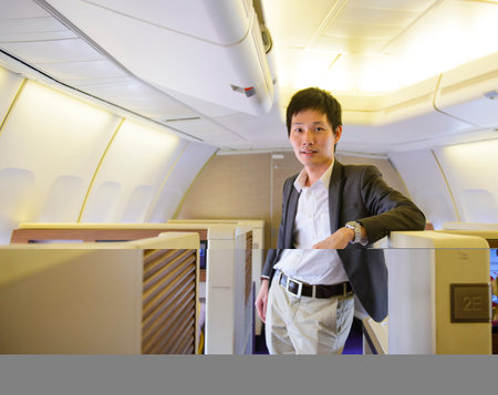 Asian businessman stand on first class cabin