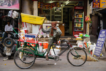 New Delhi, India April 10, 2016 : Unidentified man smoking with his rickshaw waiting for people in Paharganj, Delhiのeditorial素材