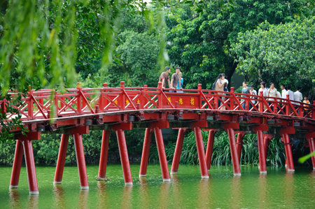 Hanoi, Vietnam - October 14, 2010 : Hanoi red bridge. The wooden red painted bridge over the Hoan Kiem Lake connects the shore and the Jade Island on which Ngoc Son Temple stands. Hanoi on October 14, 2010のeditorial素材