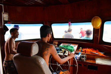 Phang Nga, Thailand - October 7, 2014 : Tourist ship crew at cockpit ahead to Koh Hong Phang Nga Bay near Phuketのeditorial素材