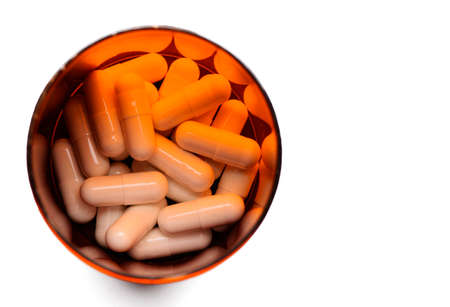 Top view of pills capsule in bottle with copy spacの写真素材