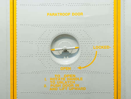 Valve open and locked paratroop door on military transport aircraftの写真素材