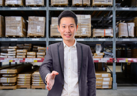 Business man handshake deal business with warehouse image blur background