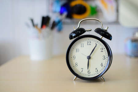 Black alarm clock on the tableの写真素材