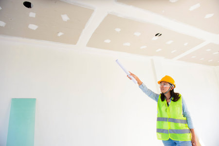 Woman engineers working in side building planning for the ceilingの写真素材