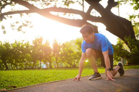 Young man ready for running on the running track in parkの写真素材