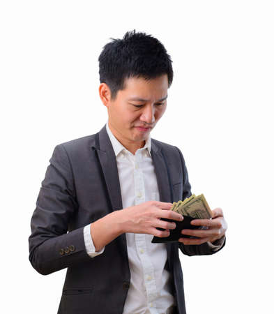Asian businessman wearing suit with empty wallet and financial difficultiesの写真素材