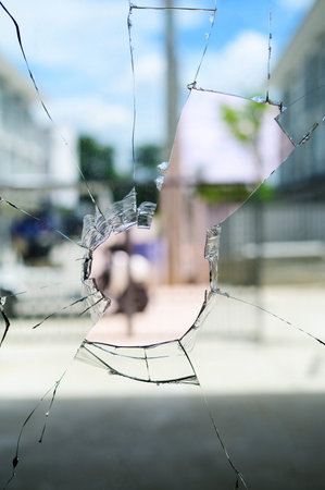 Broken cracked glass with big hole