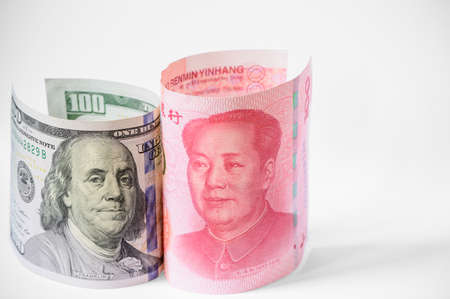 US dollar and China Yuan banknote stand up on white backgroundの写真素材