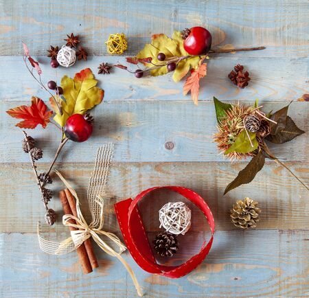 background with autumn leaves with heart shape laid on a dark blue background, also useful image for a Christmas styleの写真素材