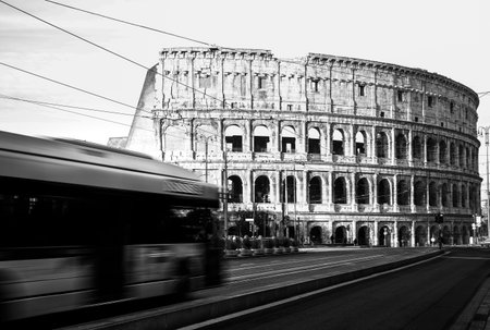 Rome Colosseum with buses moving in city traffic, travel reportage