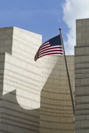 The American flag waving near one of the most important monuments of Berlin: the Brandenburg Gateの写真素材