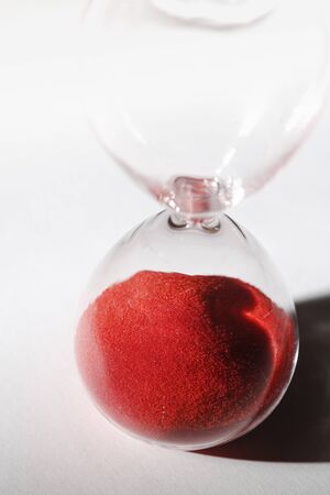 macro hourglass with red sandの写真素材