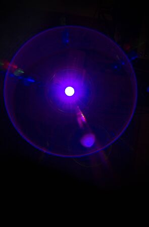 Circular light beam violet color created by a projector.の写真素材