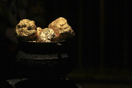 Gold nuggets within an ancient vase.の写真素材