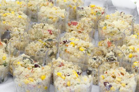 Vegetables couscous served in plastic cups.の写真素材
