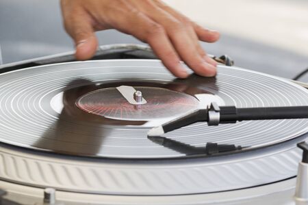 The dj uses vinyl records to mix electronic music and beat rap sound.の写真素材