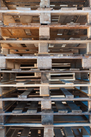 a wall of wood pallets stacked one above the other