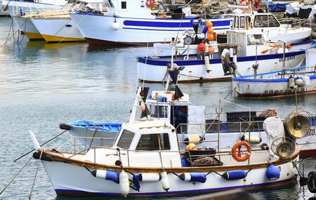 Boat for fishing boats are moored on the port of a Ligurian townの写真素材
