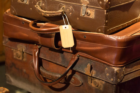 stack of brown leather suitcases used in the set design of a theatrical show