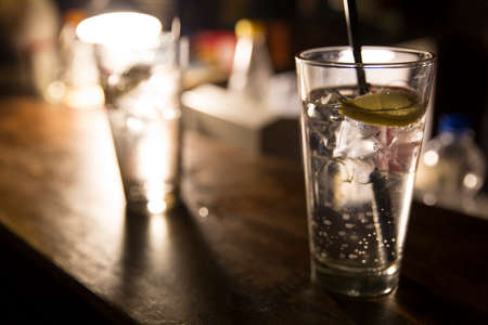 Vodka lemon with ice cubes on the barの写真素材