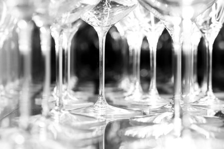 detail of wine glasses hit by light in black and whiteの写真素材