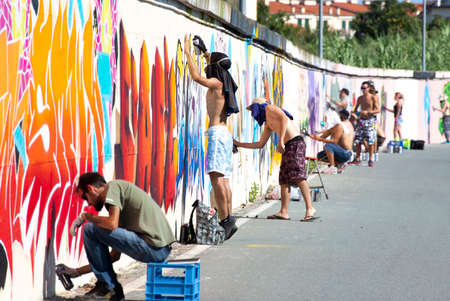 Imperia, Italy - 08/09/2018: Wall of Imperia city center, girl Graffiti Artist Spray Painting Wall Art.のeditorial素材