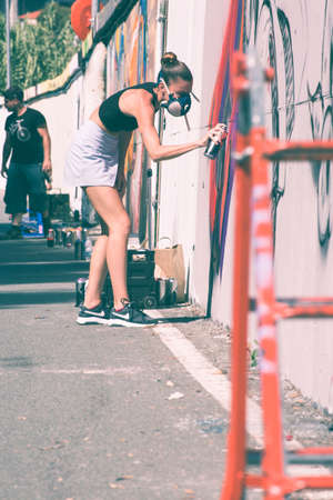 Imperia, Italy - 08/09/2018: Wall of Imperia city center, girl Graffiti Artist Spray Painting Wall Art.のeditorial素材