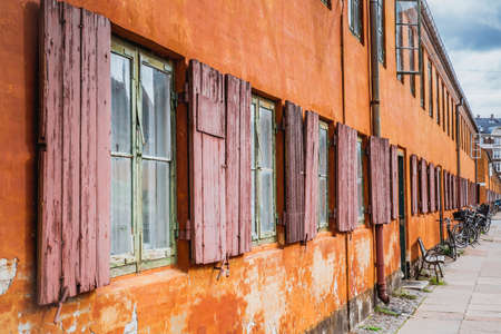 Panorama view of a typical orange house in Nyboder which is a historic row house district of former Naval barracks and was built by King Christian IVの写真素材
