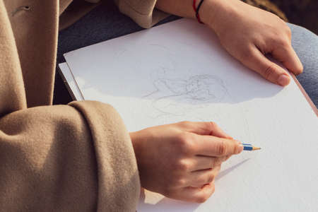 Hands of a girl drawing with pencilの写真素材