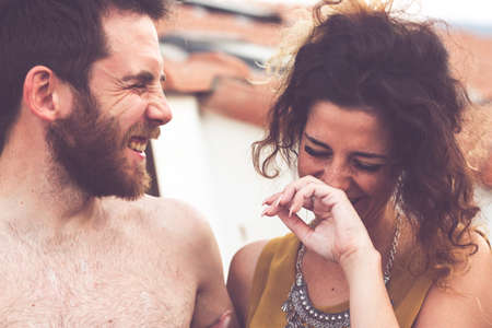 Imperia Italy, 30/06/2019: Man and woman laugh smiles in friendship during a party among friendsのeditorial素材