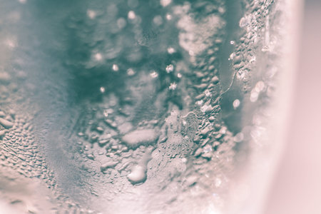 Detail of a glass with drops of sparkling wineの写真素材