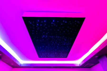 ceiling of a spa center with colored lights and geometric perspectiveの写真素材