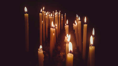 church candles lit with dramatic effectの写真素材