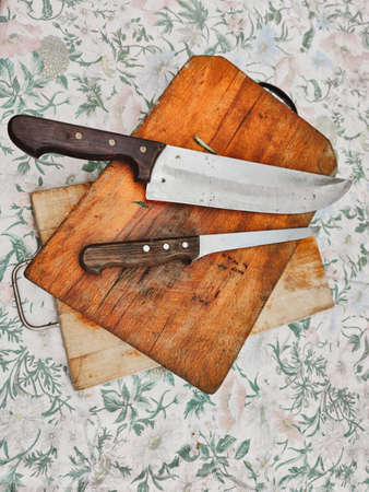 wooden chopping board with kitchen knivesの写真素材