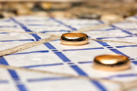 wedding ceremony rings laid on top of tiles with decorative pattern, wedding reportageの写真素材