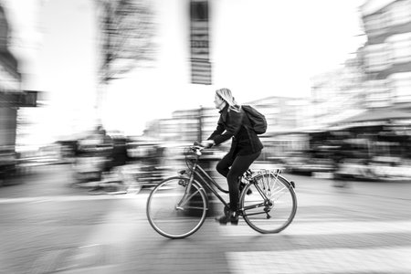 woman speed cycling in Amsterdamの写真素材