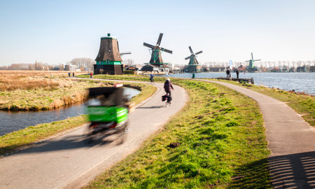 Dutch countryside with rolling mills and people in speed motionの写真素材