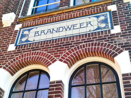 An old historic building in the city has an old Dutch fire coil sign painted on its wall.の写真素材