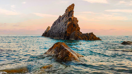 Galeazza cliff in Imperia, Italy, with calm sea and sunset sky, a natural setting ideal for travel and tourism.の写真素材