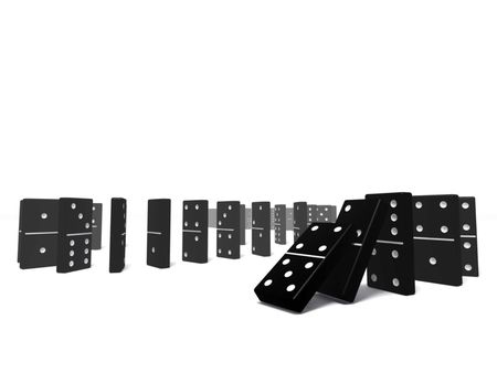 An isolated black domino blocks chain reaction on white backgroundの写真素材