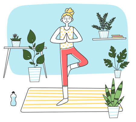Young woman standing at calm yoga postureの写真素材