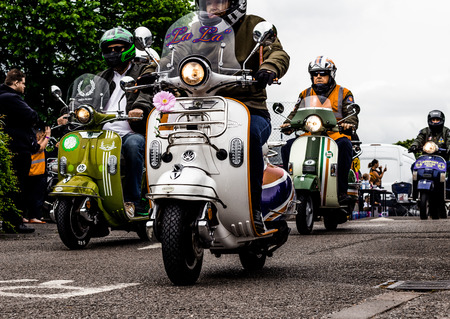 Scooter enthusiasts riding out of a rallyのeditorial素材