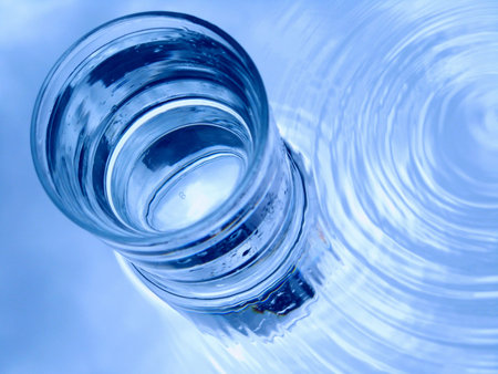 Glass of water in blueの写真素材