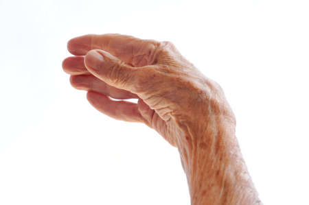 Senior woman's hand isolated on whiteの写真素材
